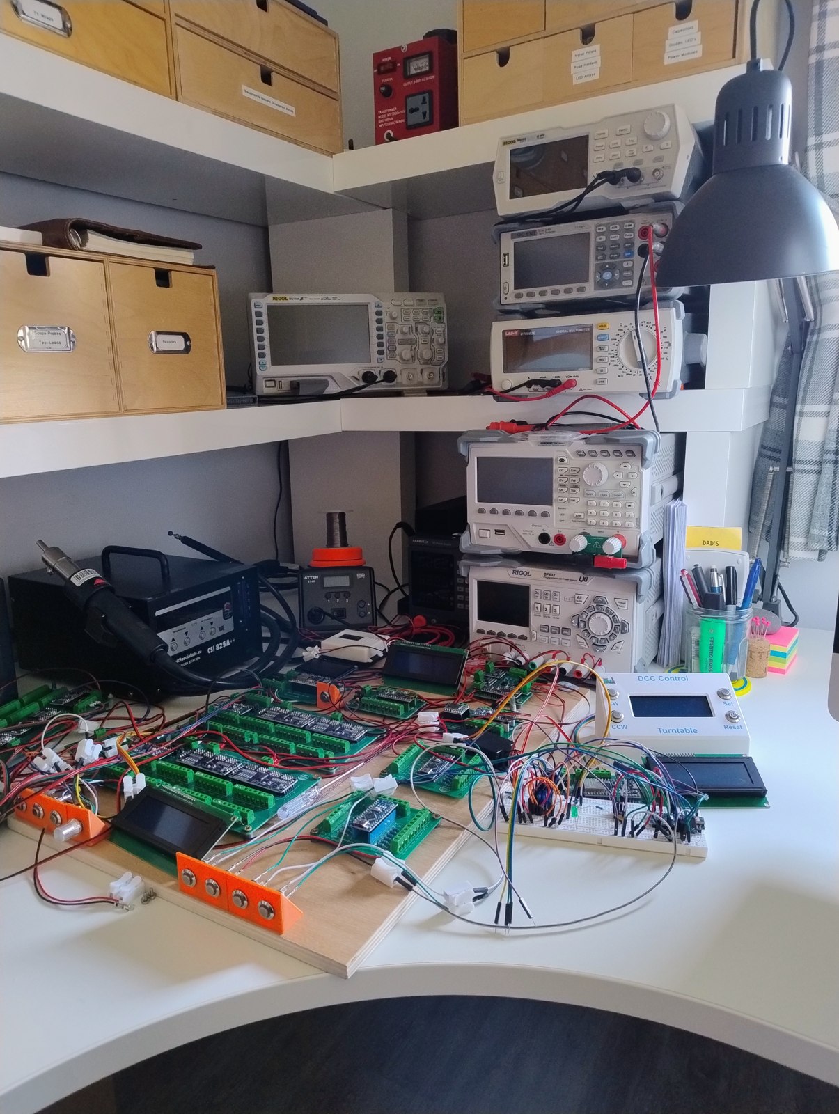 Electronics test bench with oscilloscopes and multimeters